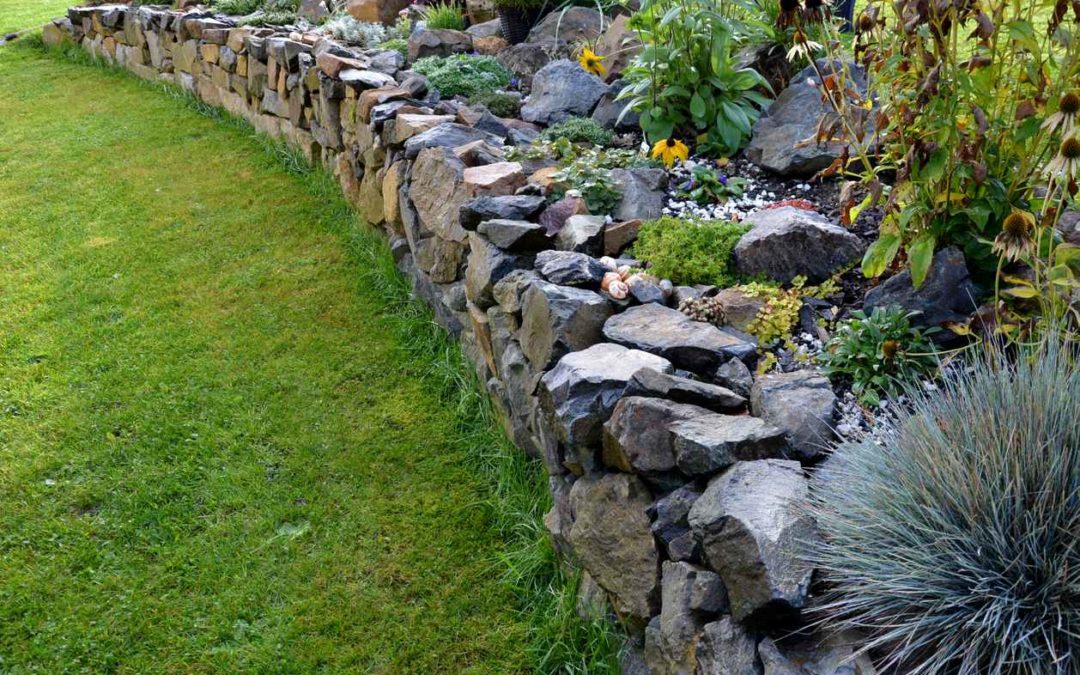 stone wall built around garden in residential yard